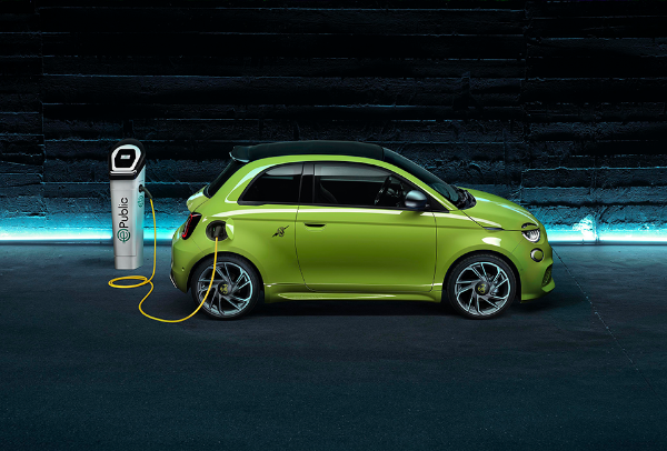 Green electric car charging at a public station.