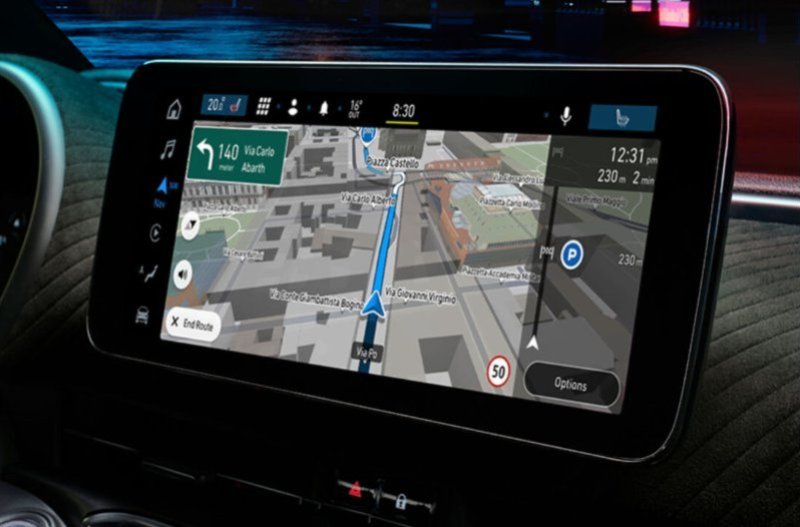 Car dashboard screen displaying a navigation map and route information.