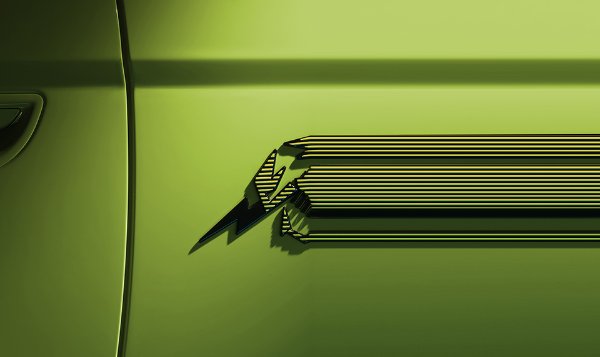 Close-up of a stylised 'M' logo on a green car door.