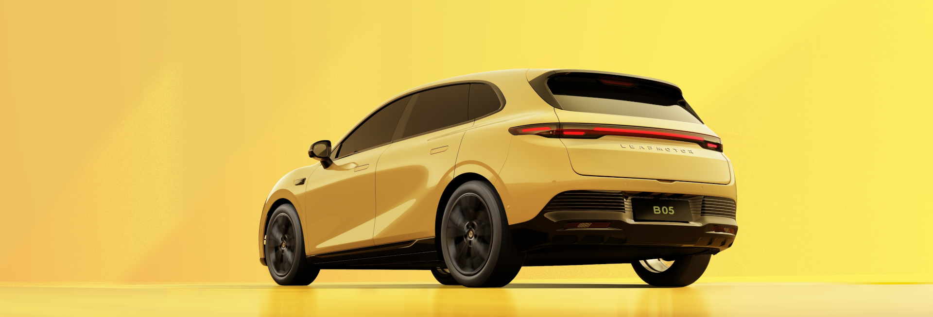 Yellow car viewed from rear-side angle, featuring a modern design and dark-tinted windows.