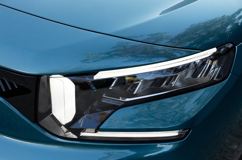 Close-up of a blue car's LED headlight design.