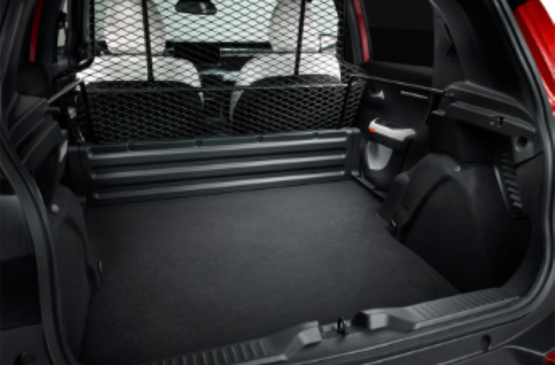 Empty boot of a car viewed from the back, with a partition net behind the rear seats.