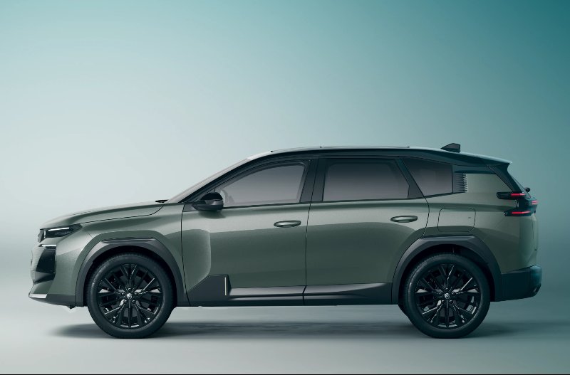 Side view of a green SUV with tinted windows and dark alloy wheels.