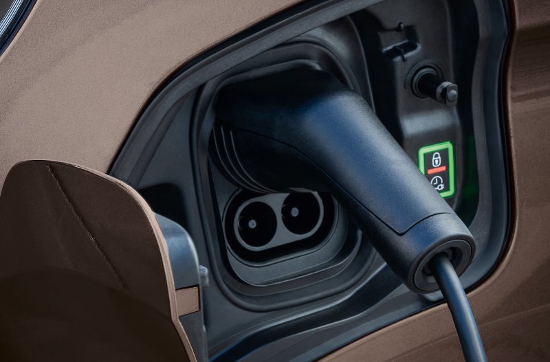 Electric car charging cable plugged into vehicle port.