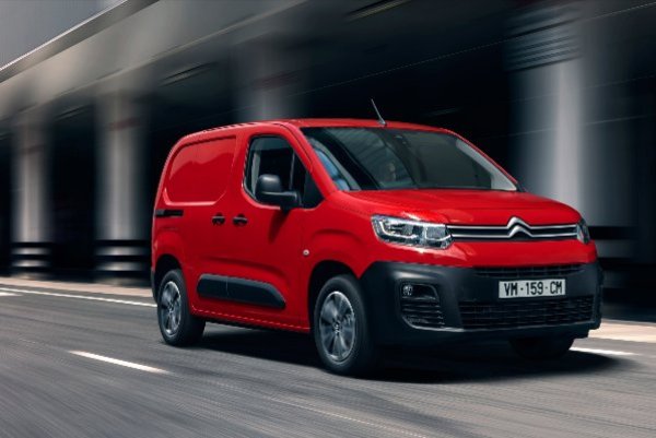 Red van driving on a road.