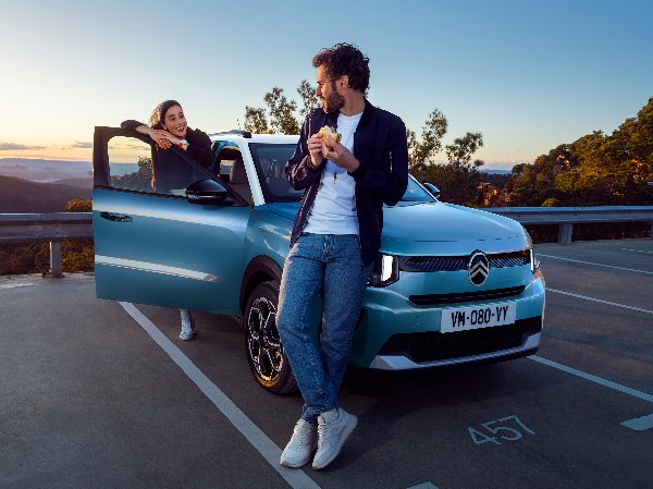 citroen c3 in blue with people standing around it