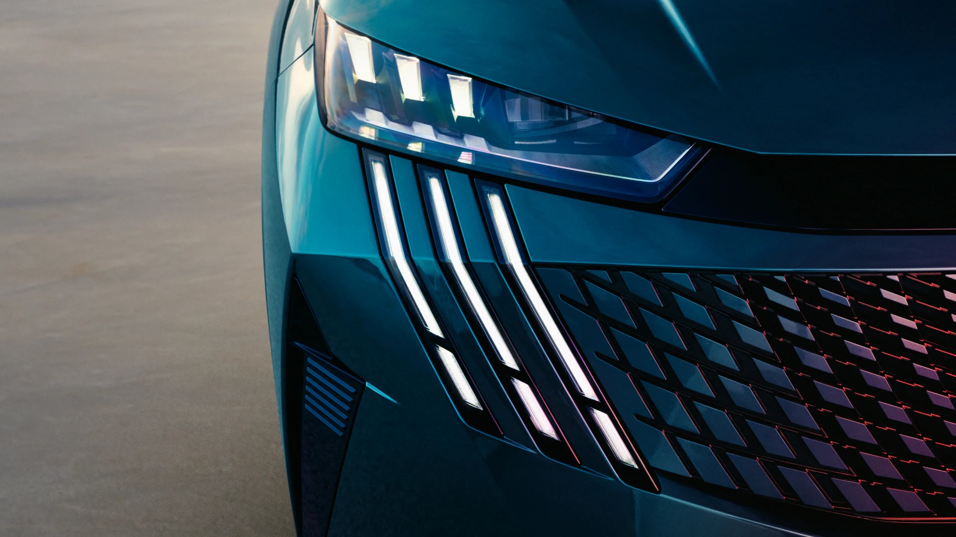 Close-up of a modern car's front headlight and grille design.