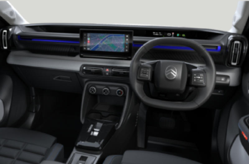 Car interior showing steering wheel, dashboard with screen, and control panel.
