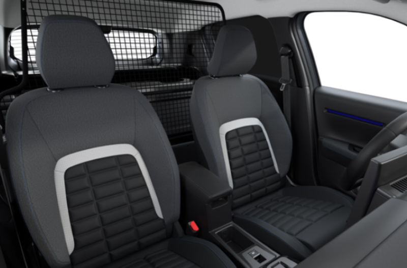 Front seats and dashboard of a vehicle with a metal partition behind the seats.