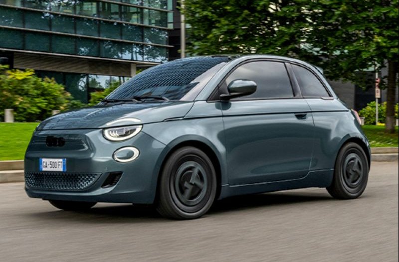 Grey compact car driving on a road.