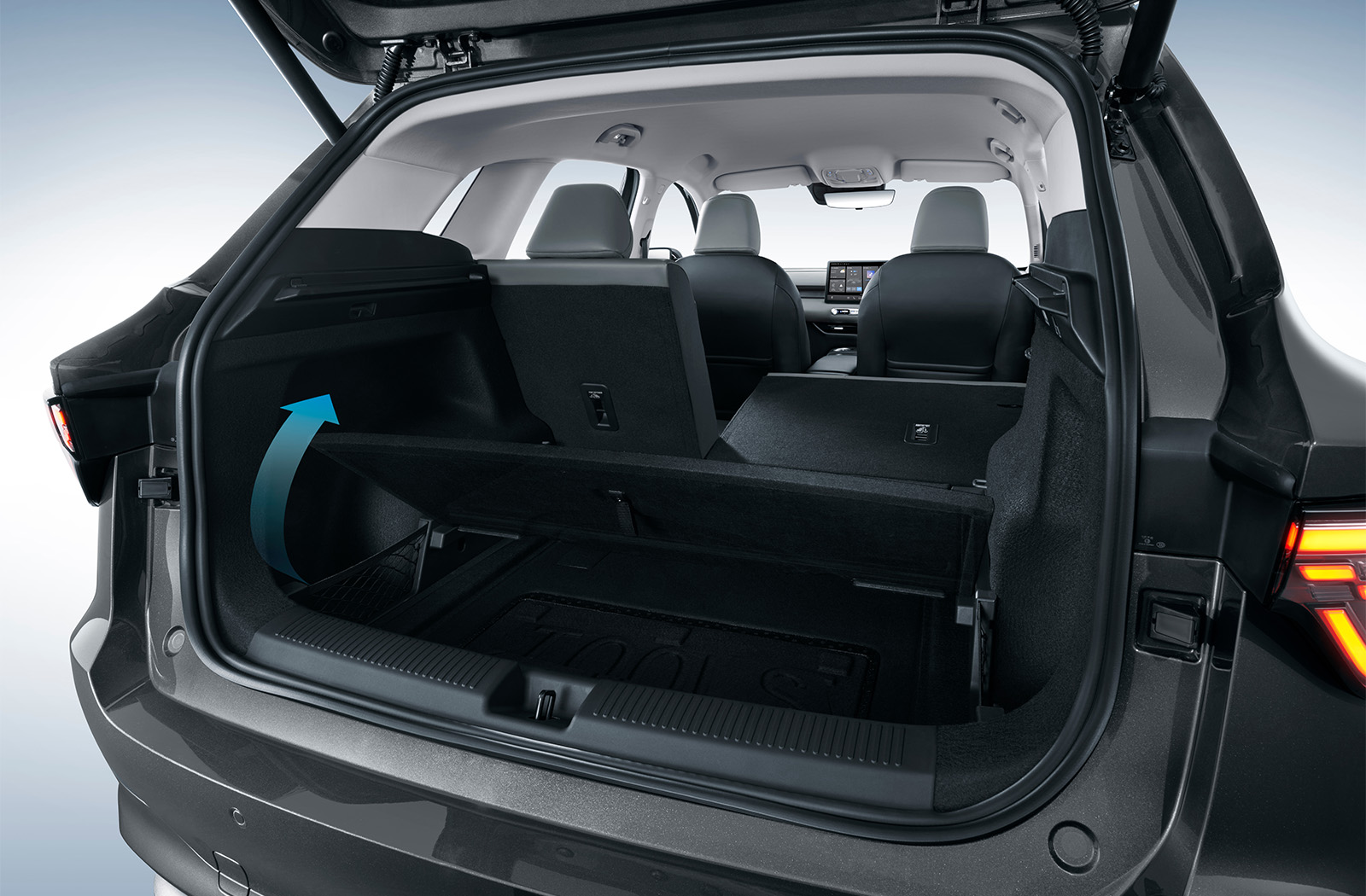 Car boot interior with raised floor compartment and rear seats visible.