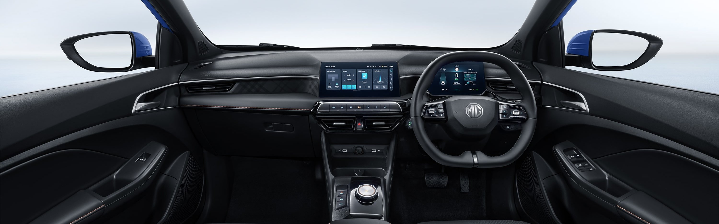 Car interior showing steering wheel, dashboard with digital displays, and two front seats.