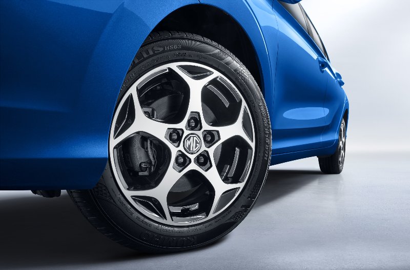 Close-up of a blue car's rear wheel and tyre with MG logo.