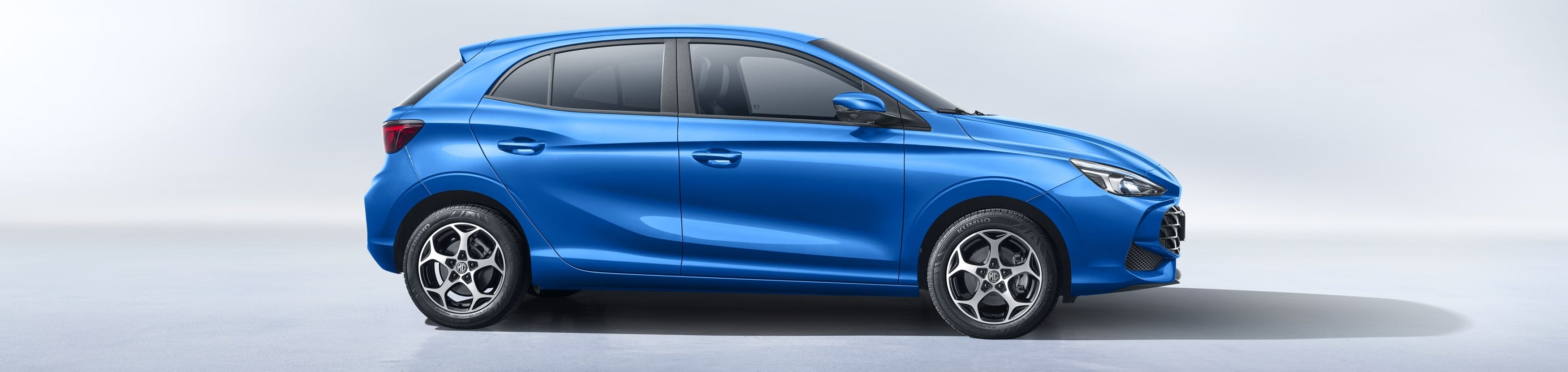 Blue hatchback car in side profile view.
