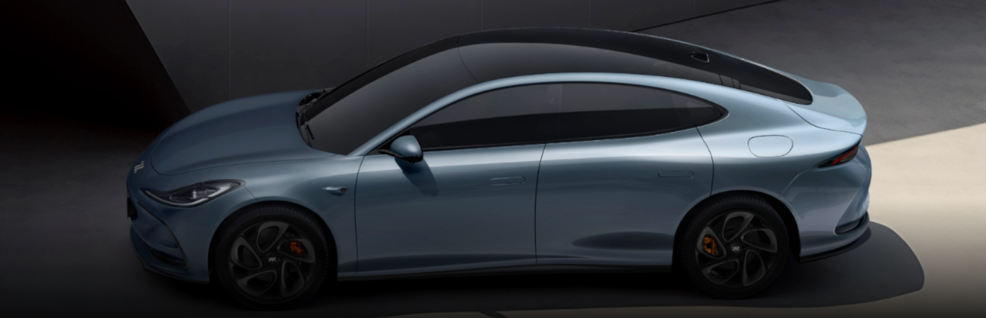 Sleek blue saloon car viewed from above and the side.