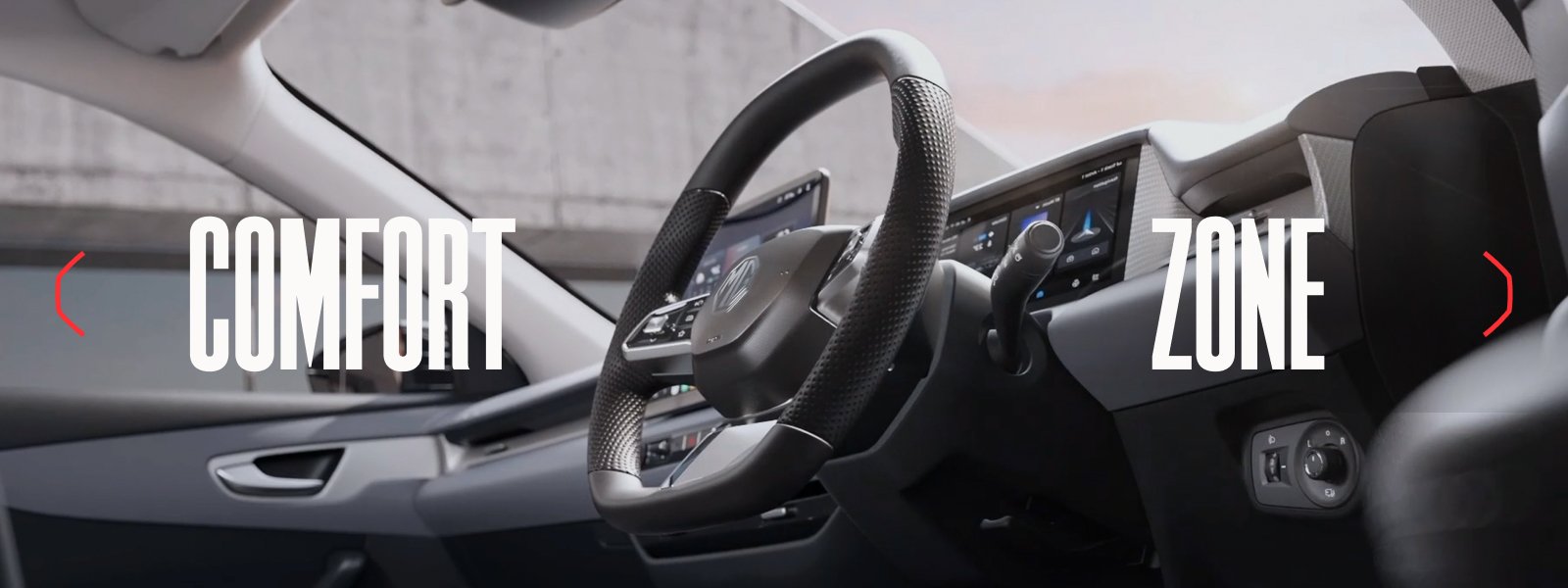 Car interior with a digital display and a textured steering wheel. Words Comfort Zone overlaid.