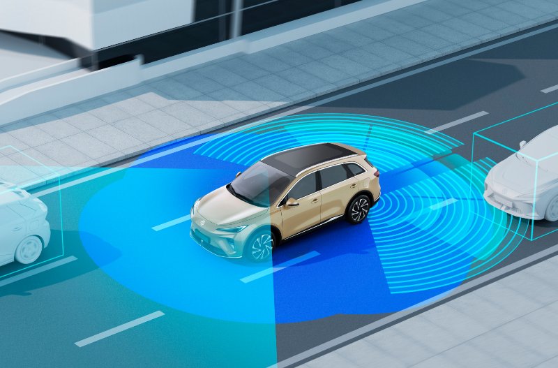 Autonomous vehicle on road with visual sensor range display.