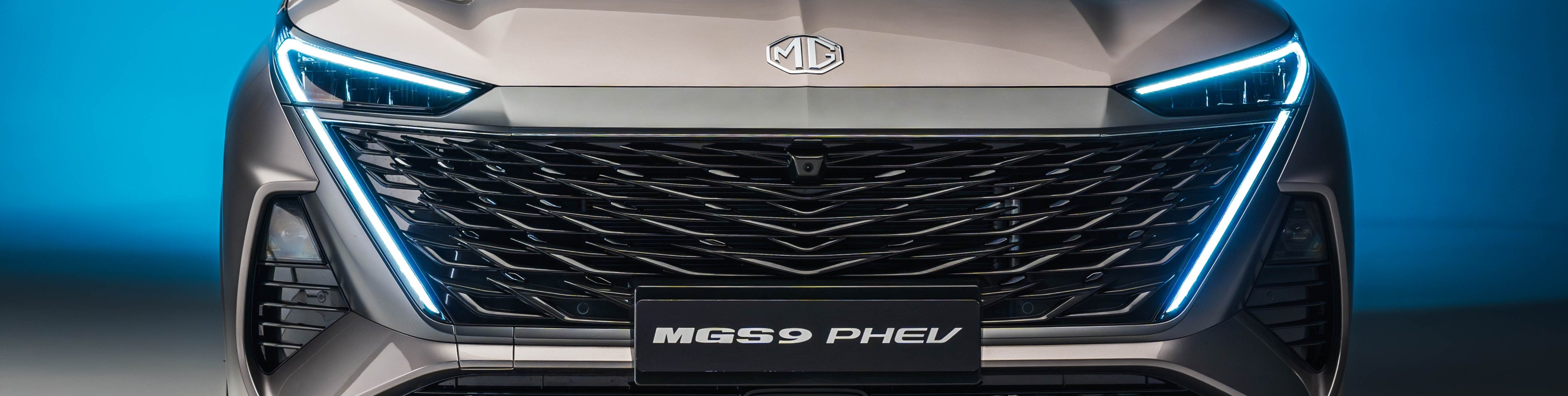 Front view of a car with LED headlights and a prominent grille.