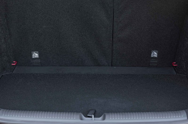 Car boot interior with rear seats up and black fabric lining visible.