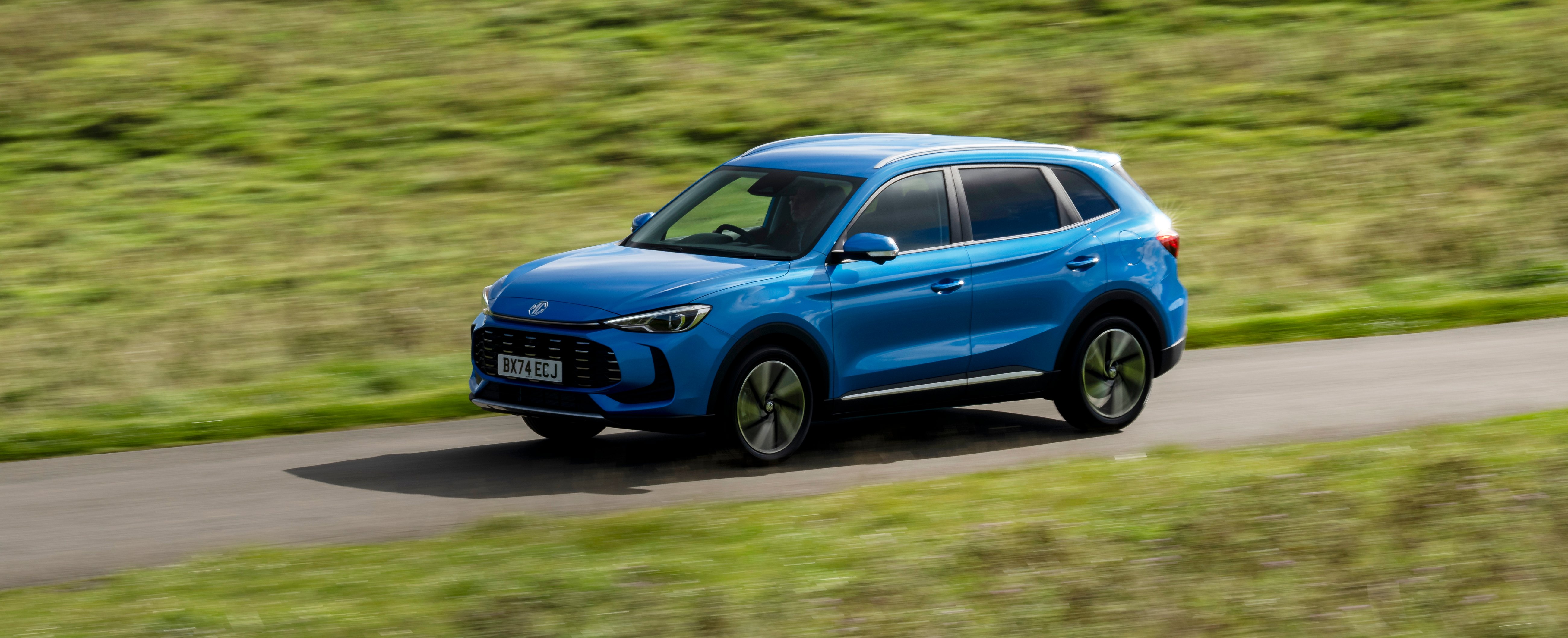 Blue SUV driving on a rural road.