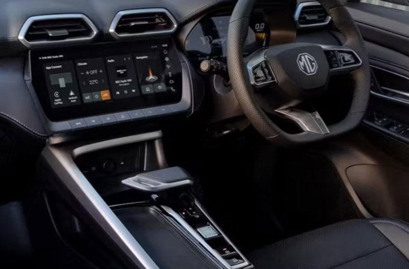 Car interior with modern touchscreen display and MG branded steering wheel.