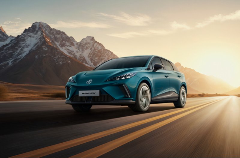 A blue car driving on a road with mountains in the background at sunset.
