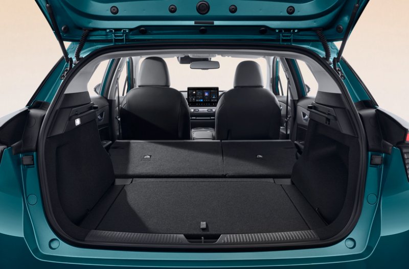 Open car boot with folded rear seats, showing interior space and dashboard.
