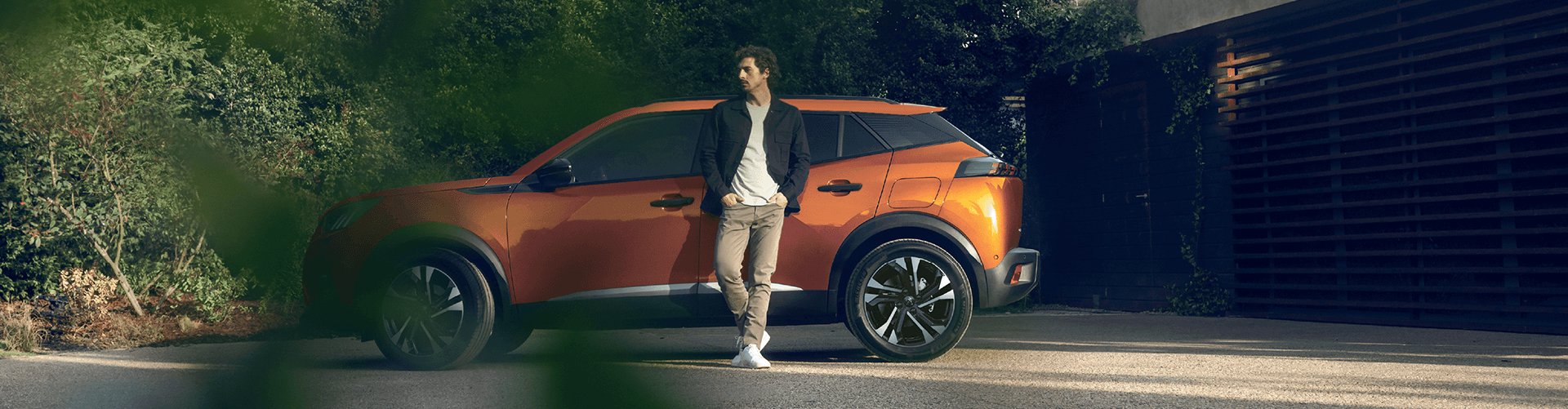 peugeot 2008 in orange with man in front