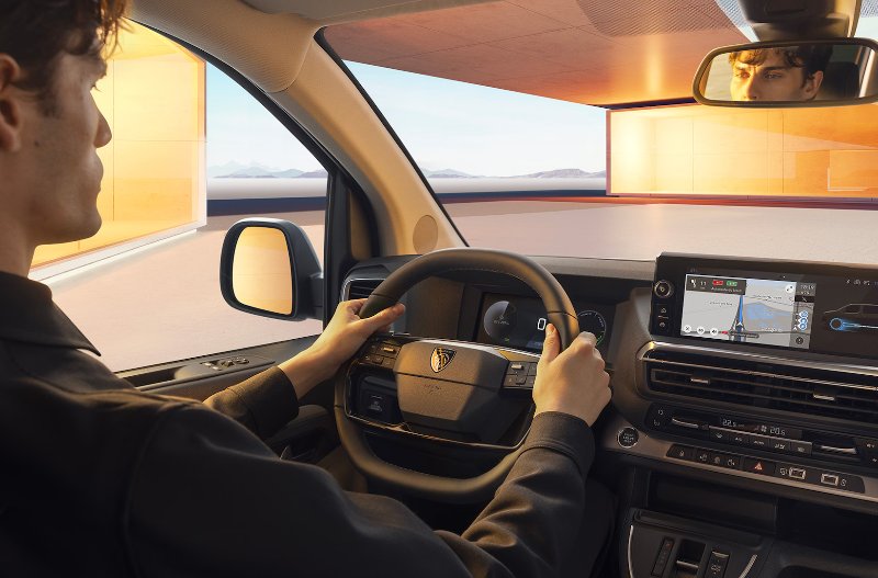 man sat driving peugeot e traveller