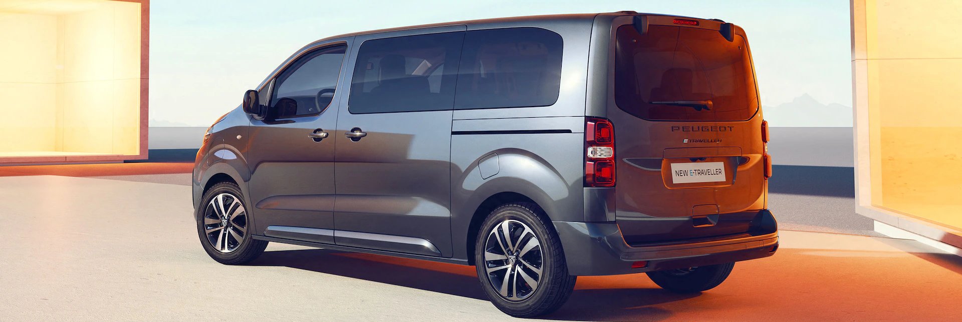 Silver Peugeot van viewed from the rear side with tinted windows and modern design.