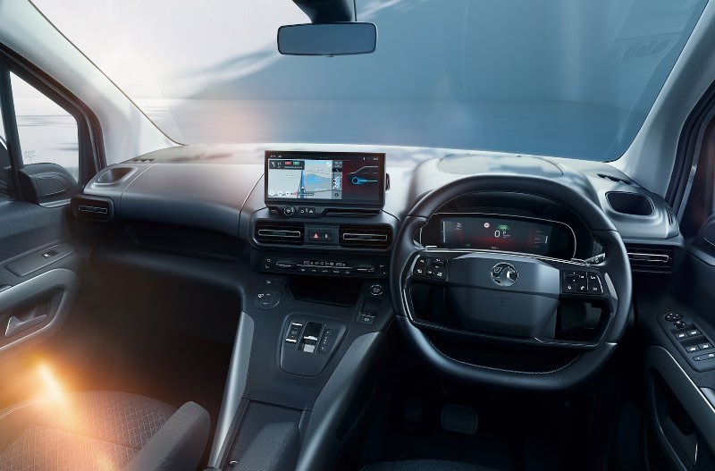 Car interior with multifunction steering wheel, touchscreen display and digital dashboard.