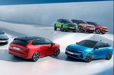 Five cars of various colours displayed on a reflective surface.