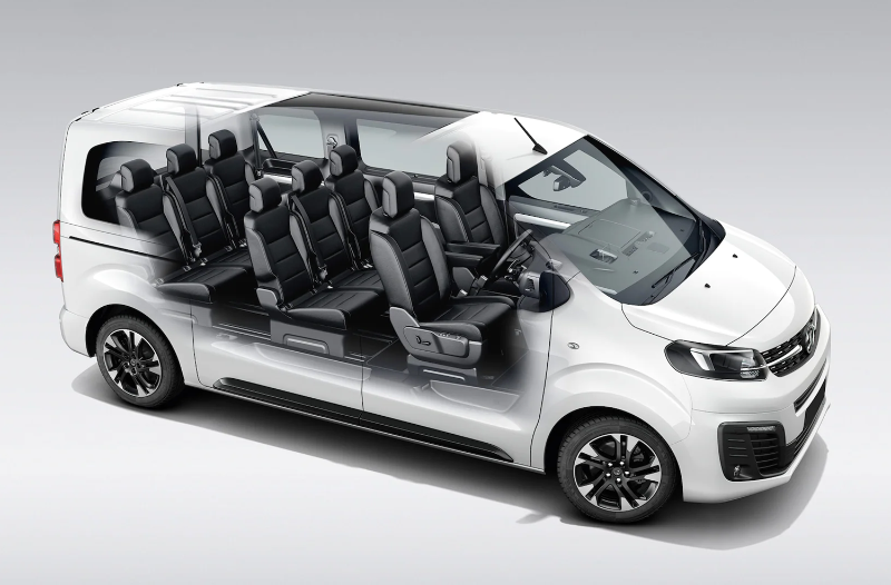 Cutaway view of a white van showing interior seating arrangement.