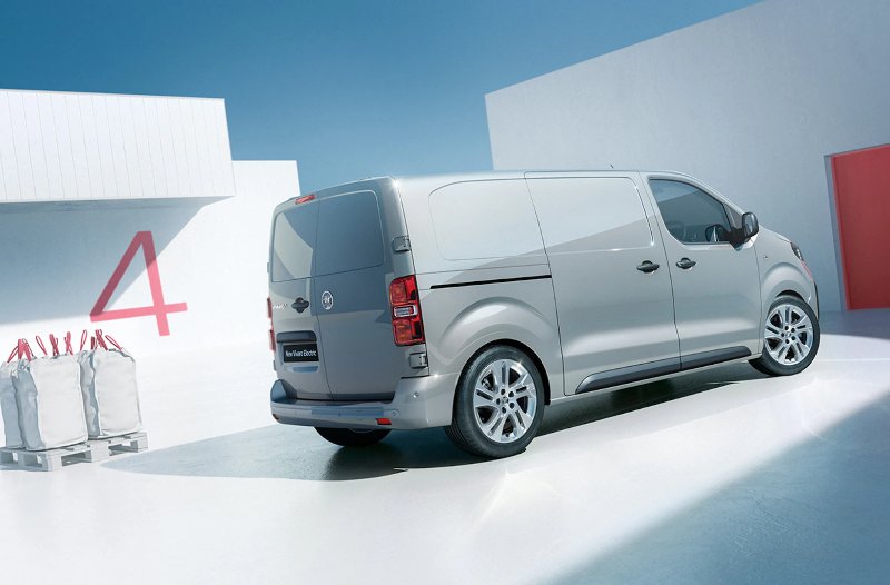 Silver electric van next to pallets and a large red number 4 on the wall.